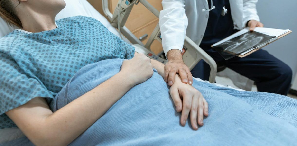 doctor touching the arm of a patient
